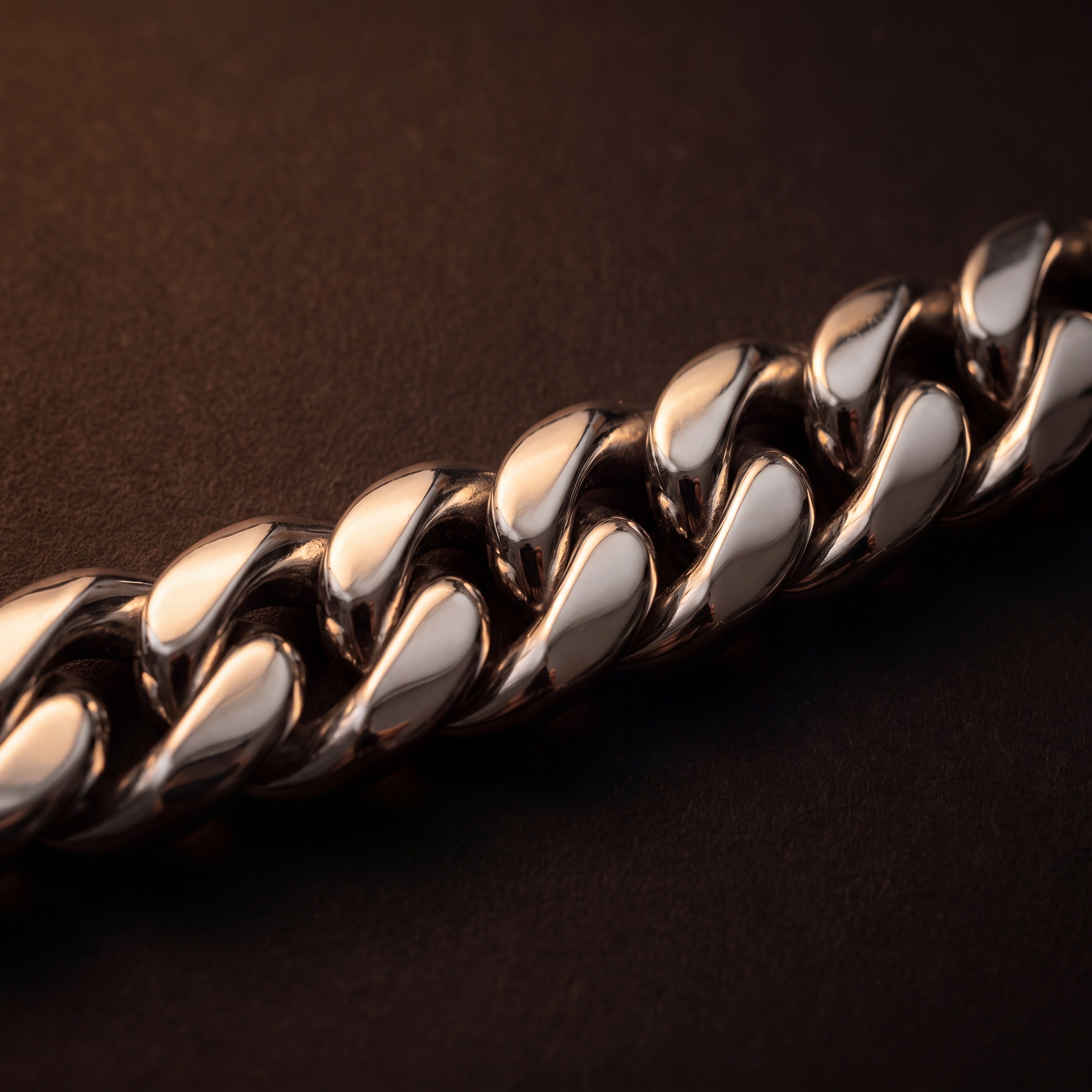 Close-up of the smooth domed links on a polished stainless steel Miami Cuban bracelet